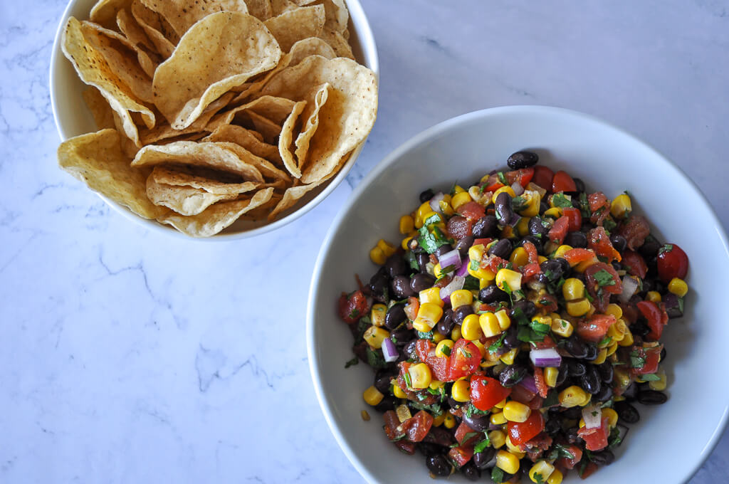 overhead shot of black bean and corn salsa served with chips